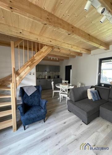 a living room with a couch and a table at Domki Błażejewo in Łukęcin