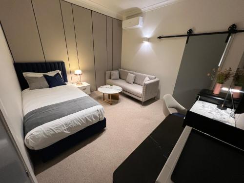 a hotel room with a bed and a couch at Lismore City Motor Inn in Lismore