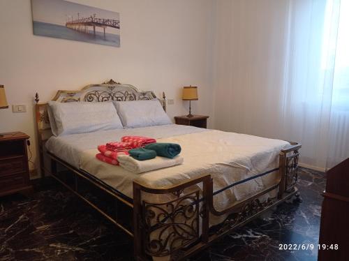 a bedroom with a bed with two towels on it at DOWN TOWN EMILY in La Spezia