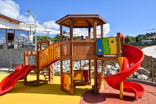 a playground with a slide and a slideintend at Wine & SPA Hotel Chukara in Tryavna