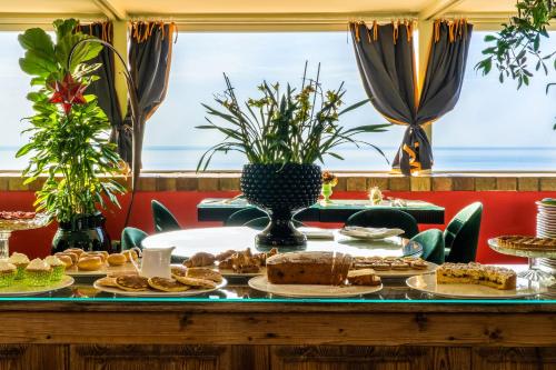 a table with pastries and breads on it at Hotel Villa Carlotta in Taormina