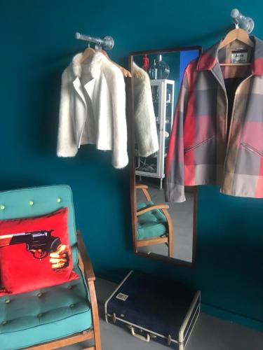 a dressing room with a mirror and a chair at Chy conary in Carbis Bay