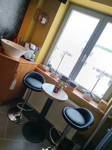 a kitchen with two chairs and a table in front of a window at *Wallonie14* in Malmedy