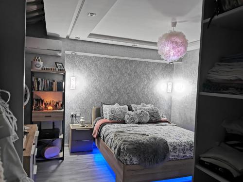 a bedroom with a bed with a purple comforter at Big, stylish and modern apartment with hot tub in Tangier