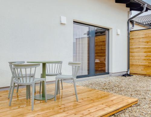 a room with a table and chairs on a patio at Limehome Bodenmais Bahnhofstraße in Bodenmais