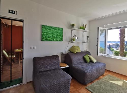 a living room with a couch and a chair at Apartments Nea by Locap Group in Portorož