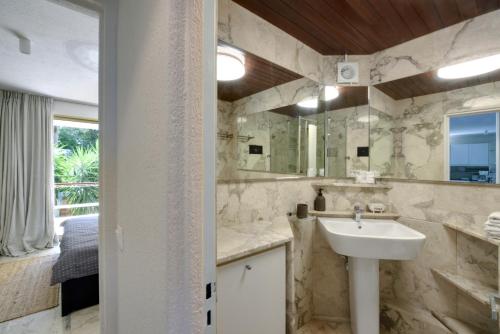 a bathroom with a sink and a mirror at Kavouri Flat in Athens