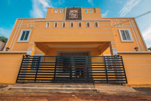 a yellow building with a gate in front of it at Saffron Vilva in Puducherry