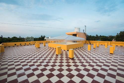 a row of yellow benches on a roof at Saffron Vilva in Puducherry