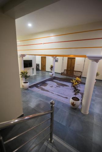 a lobby with two potted plants in a building at Saffron Vilva in Puducherry