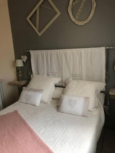 a white bed with white pillows and a pink blanket at Gîte en Pays Cathare in Pomas