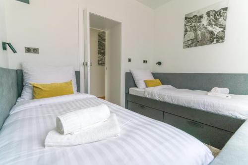 two beds sitting next to each other in a bedroom at ChaletSKI Jasná, SKI-IN & SKI-OUT in Demanovska Dolina