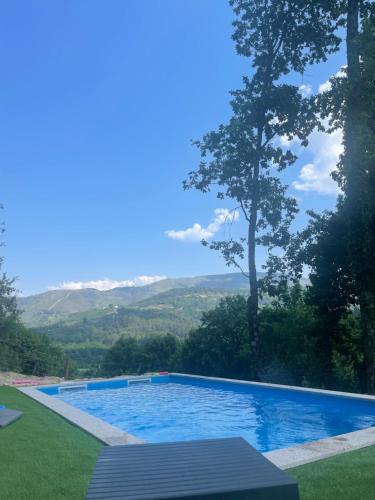 a swimming pool with a view of the mountains at Casa do Tapadinho in Ribeira de Pena