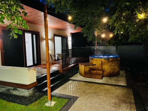 a house with a hot tub in the yard at WRZOS resort & wellness **** DOMKI CAŁOROCZNE in Węgierska Górka