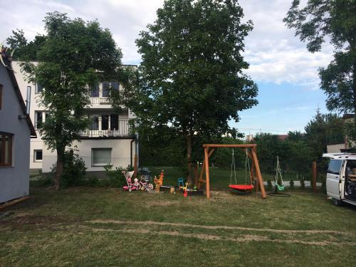 a yard with a swing set in the grass at Domek na Skarpie in Sztutowo