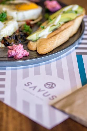 a plate of food on a table with a plate of food at SAVUS Boutique Hotel in Rethymno Town