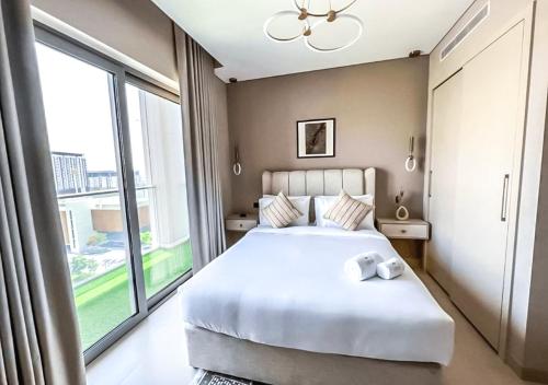 a bedroom with a large bed and a large window at STAY BY LATINEM Luxury 2BR Holiday Home CV B609 Near Burj Khalifa in Dubai