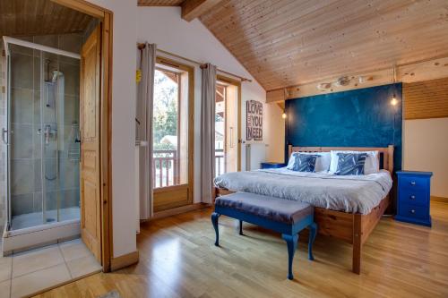 a bedroom with a large bed and a shower at Chamonix Large Chalet, Sleeps 12, 200m2, 5 Bedroom, 4 Bathroom, Garden, Jacuzzi, Sauna in Chamonix-Mont-Blanc