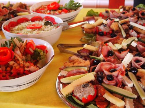 a table topped with bowls of different types of food at Casa Ardeleneasca in Timişoara