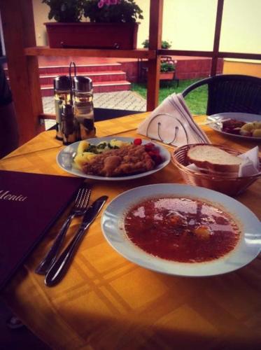 a wooden table with plates of food on it at Casa Ardeleneasca in Timişoara
