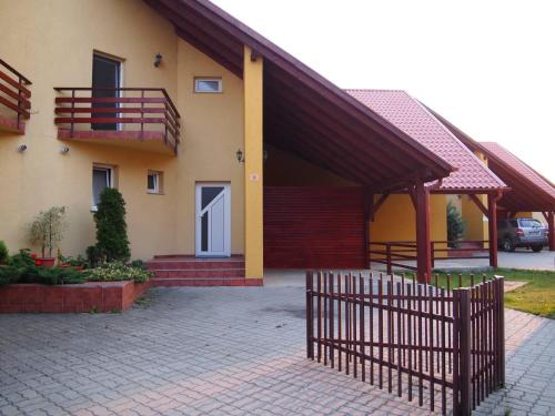 a house with a fence in front of it at Casa Ardeleneasca in Timişoara