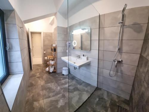 a bathroom with a sink and a shower at CHG BOUTIQUE HOTEL in Costinesti