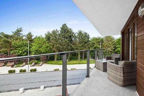 a balcony with a view of a park at Maloves Resort & Spa in Władysławowo