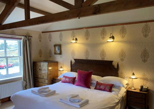 a bedroom with a large bed with towels on it at The Charles Bathurst Inn in Richmond