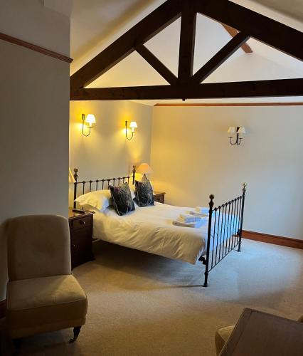 a bedroom with a bed and a chair in a room at The Charles Bathurst Inn in Richmond