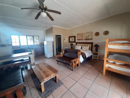 a living room with a bed and a couch at Tourist Lodge Gansbaai in Gansbaai
