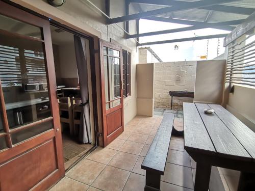 a room with a wooden bench and a table at Tourist Lodge Gansbaai in Gansbaai