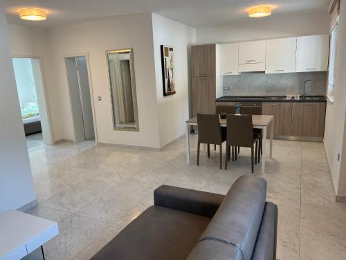 a living room and kitchen with a couch and a table at VILLA SILVIA - FUNTANA in Funtana