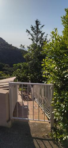a white gate on top of a house at A Tana di a Volpe in Alzetu