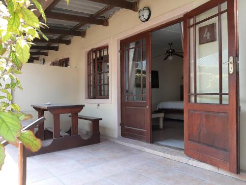 an open door to a patio with a table and a clock at Tourist Lodge Gansbaai in Gansbaai