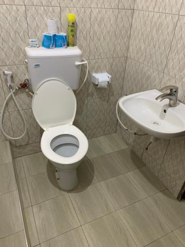 a bathroom with a toilet and a sink at Pazuri Hostel in Moshi