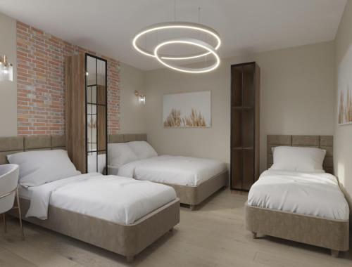 a bedroom with two beds and a chandelier at Struga Riverview Hotel in Struga
