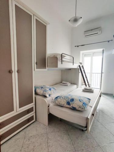 two bunk beds in a room with a closet at Casa Vacanze Da Serena in Lacco Ameno