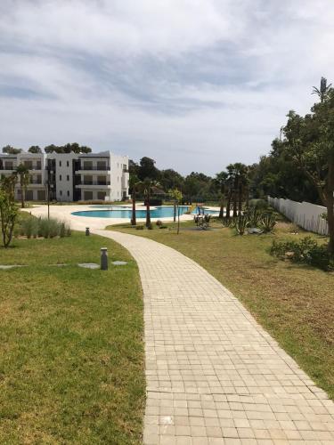 a brick walkway leading to a swimming pool at Soleil & Compagnie Cabo Huerto in Cabo Negro