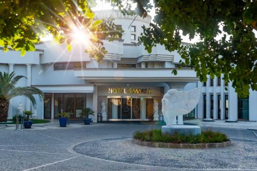a building with a statue in front of it at Samara Hotel Bodrum Ultra All Inclusive in Torba