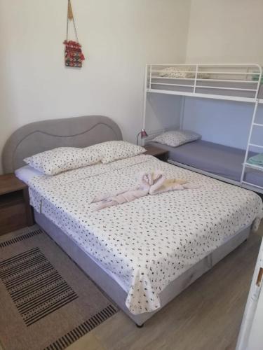 a bedroom with a bed with a pink bow on it at Nikini dvori in Gradac
