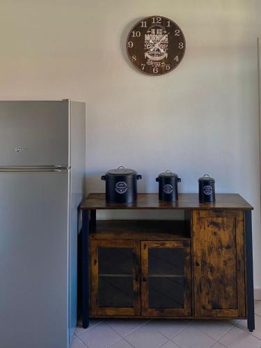 a table with three pots on it next to a refrigerator at IL NIDO DI CHLOE cod. citra 011027-LT-0239 in Sarzana