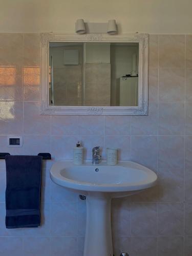 a bathroom with a white sink and a mirror at IL NIDO DI CHLOE cod. citra 011027-LT-0239 in Sarzana