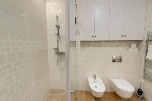 a bathroom with a shower and a toilet and a sink at Romantic riverview Bestern in Szeged