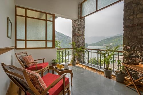 a balcony with chairs and a view of the water at The Fishermen's Lodge by Leisure Hotels in Bhīm Tāl