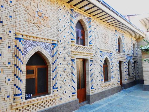 a building with tiled walls and windows on it at Colibri Traditional Hostel in Samarkand