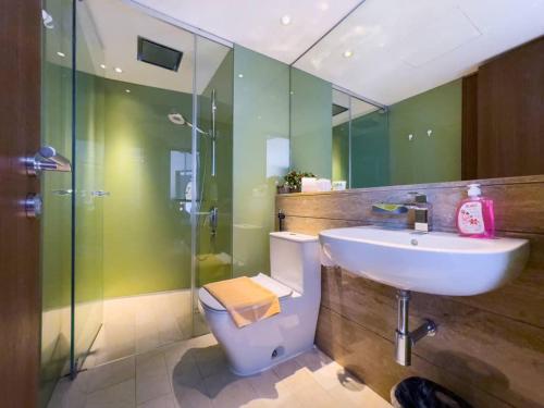 a bathroom with a sink and a toilet and a shower at The Luxury Penthouse Twin Tower view in Kuala Lumpur