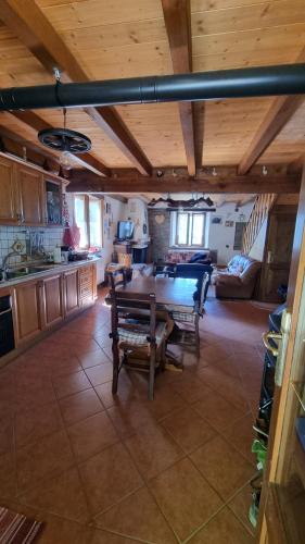 a kitchen and living room with a table and chairs at La casina del Castiglione in Riolunato