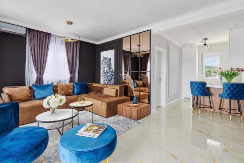 a living room with a couch and blue chairs at Kotor Rooftop Apartments in Kotor