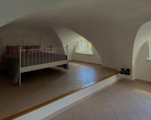 a bedroom with a crib in a room with an arch at IL NIDO DI CHLOE cod. citra 011027-LT-0239 in Sarzana