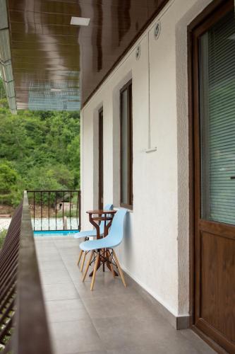 a porch with a chair and a table on a house at Spitak tun in Ijevan